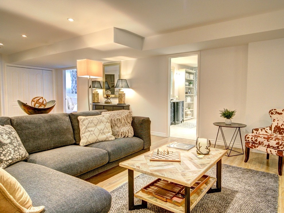 Example of a large transitional look-out light wood floor and beige floor basement design with gray walls and no fireplace