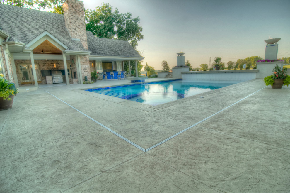 Large transitional backyard concrete paver and rectangular natural hot tub photo in Cedar Rapids