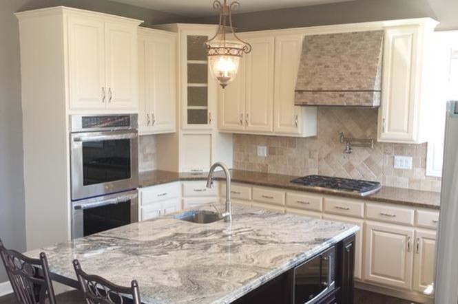 Small contemporary l-shaped separate kitchen in Chicago with granite benchtops, beige splashback, travertine splashback, panelled appliances, with island, an undermount sink, raised-panel cabinets, white cabinets, dark hardwood floors and brown floor.