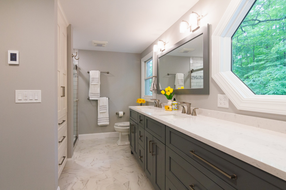 Inspiration for a mid-sized transitional master green tile and ceramic tile porcelain tile, white floor and double-sink sliding shower door remodel with shaker cabinets, gray cabinets, a two-piece toilet, an undermount sink, quartz countertops, white countertops, a niche and a built-in vanity