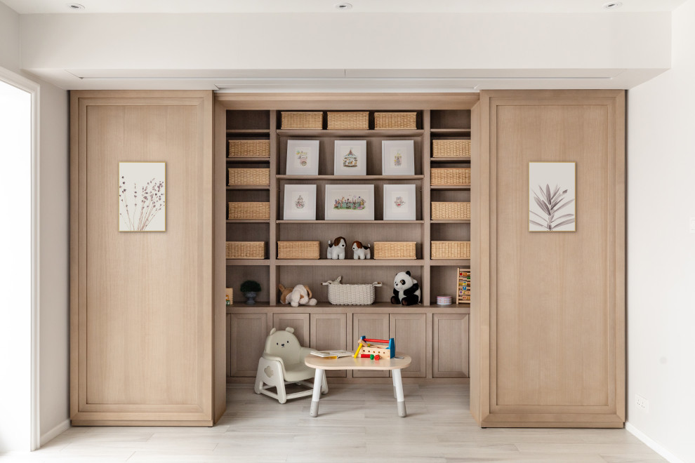 Large contemporary gender-neutral kids' playroom in Hong Kong with grey walls and beige floor for kids 4-10 years old.