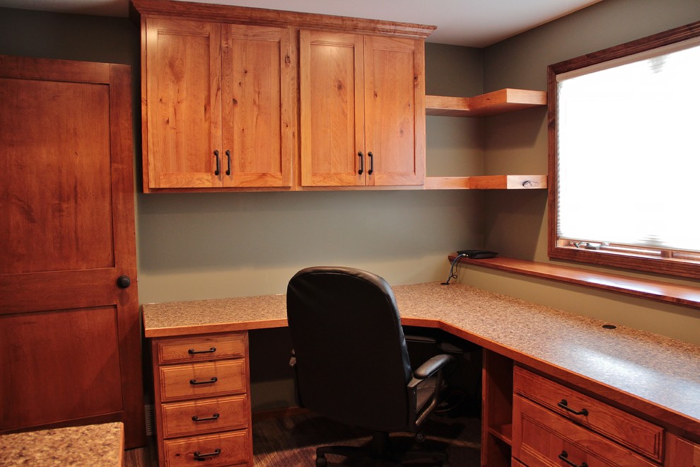 Example of a mid-sized mountain style built-in desk carpeted home design design in Minneapolis with green walls and no fireplace