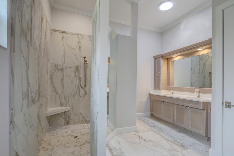 Mid-sized beach style bathroom in Tampa with recessed-panel cabinets, medium wood cabinets, an open shower, beige tile, travertine, grey walls, marble floors, an undermount sink, marble benchtops, white floor and a shower curtain.