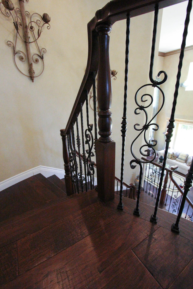 Photo of a large traditional wood curved staircase in San Francisco with tile risers.