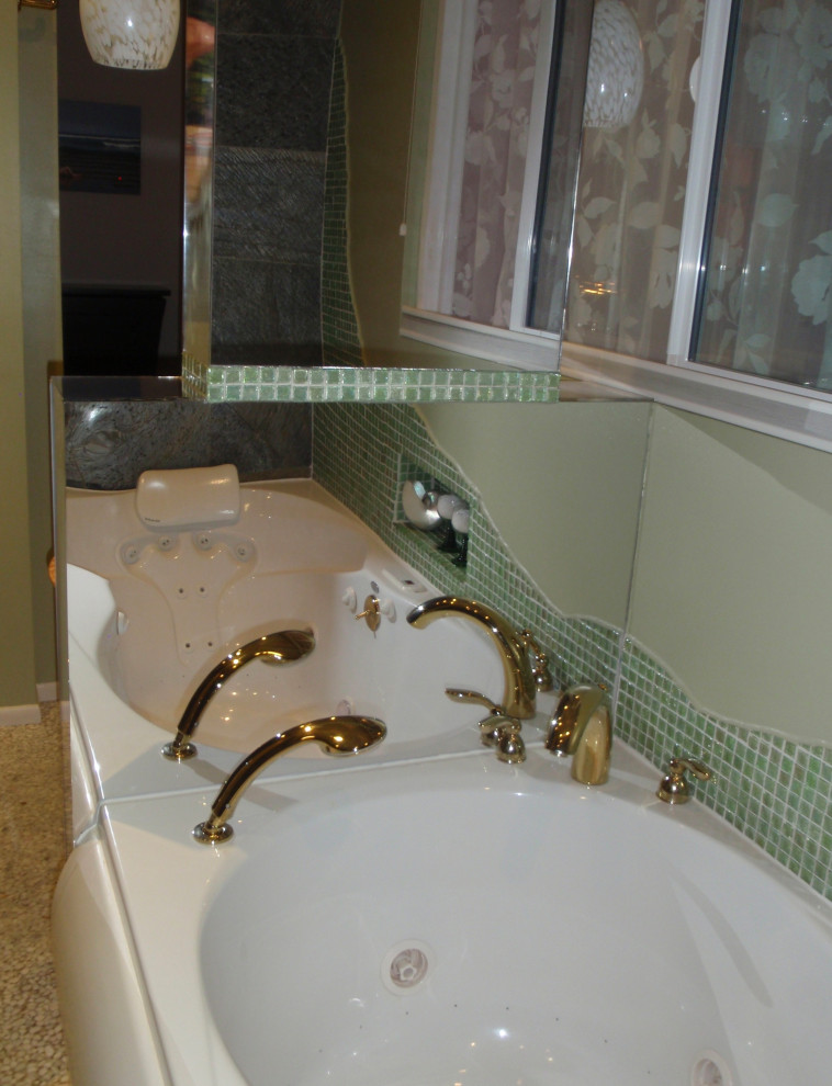 This is an example of a mid-sized contemporary master wet room bathroom in Other with furniture-like cabinets, light wood cabinets, a drop-in tub, a wall-mount toilet, green tile, slate, green walls, pebble tile floors, a vessel sink, wood benchtops, white floor, an open shower, a niche, a single vanity and a freestanding vanity.