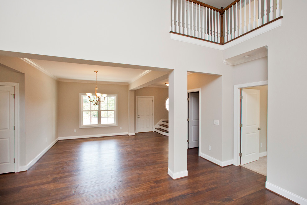 Large transitional open concept family room in Raleigh with grey walls and dark hardwood floors.