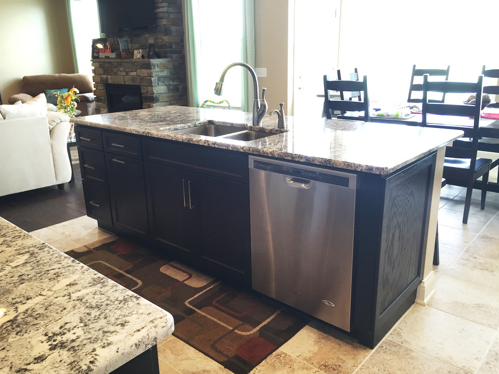 Example of a mid-sized transitional l-shaped open concept kitchen design with black cabinets, stainless steel appliances, an island, an undermount sink, recessed-panel cabinets and multicolored backsplash