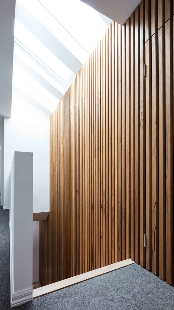 Inspiration for a large contemporary wood l-shaped staircase in Melbourne with wood risers and wood railing.