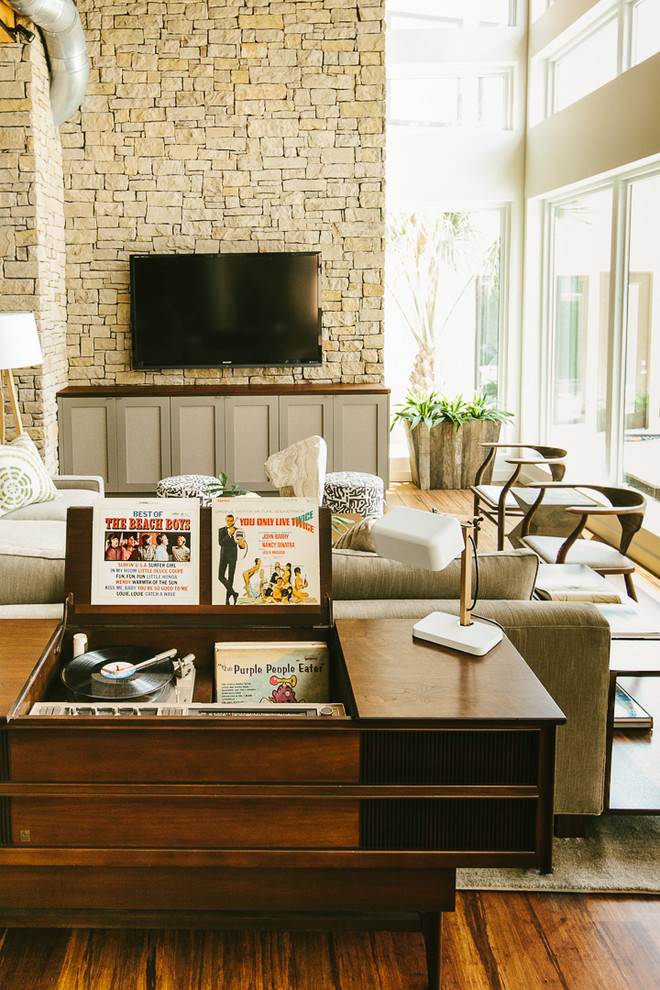 Living room - 1950s open concept medium tone wood floor living room idea in Austin with a wall-mounted tv