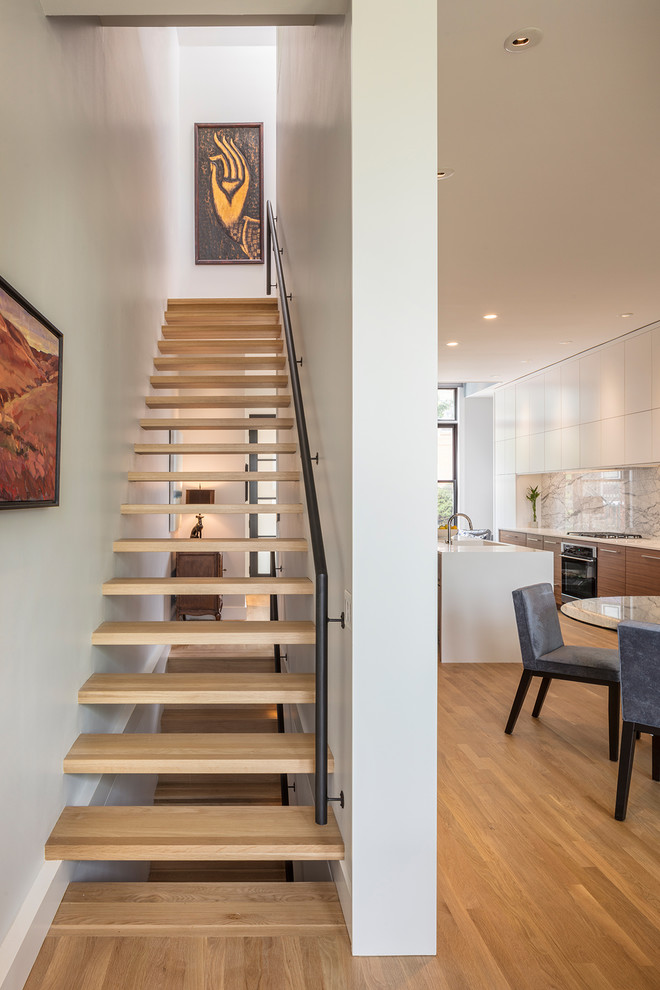 Inspiration for a mid-sized wood floating staircase in Kansas City with open risers and metal railing.