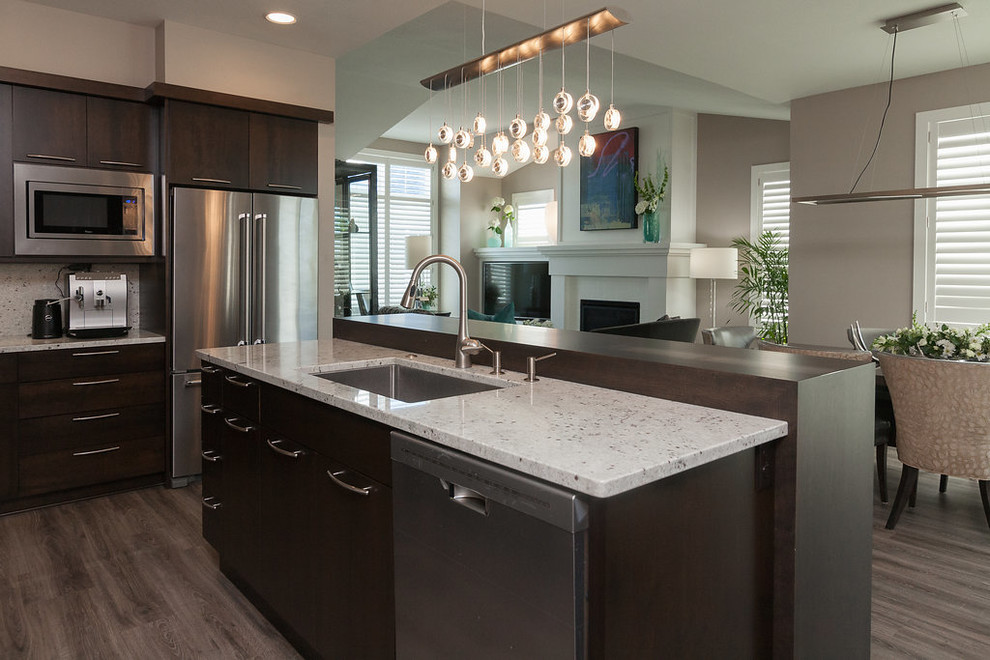 Large transitional l-shaped dark wood floor and brown floor eat-in kitchen photo in Minneapolis with an undermount sink, flat-panel cabinets, dark wood cabinets, granite countertops, white backsplash, stone slab backsplash, stainless steel appliances and an island