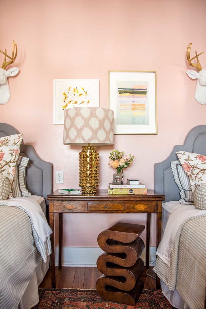 Photo of a mid-sized eclectic guest bedroom in Atlanta with pink walls.
