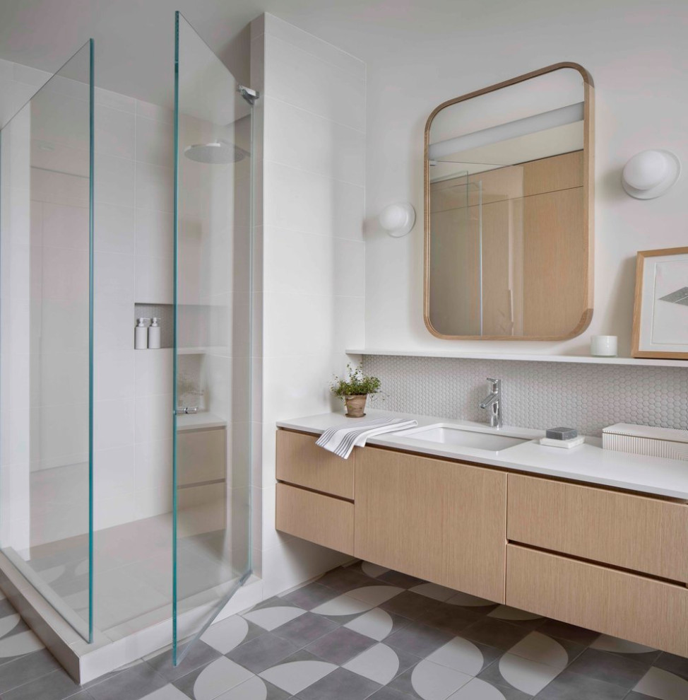 Medium sized modern ensuite wet room bathroom in Chicago with flat-panel cabinets, white tiles, white walls, cement flooring, a submerged sink, engineered stone worktops, a hinged door, white worktops, a single sink, light wood cabinets, multi-coloured floors and a floating vanity unit.