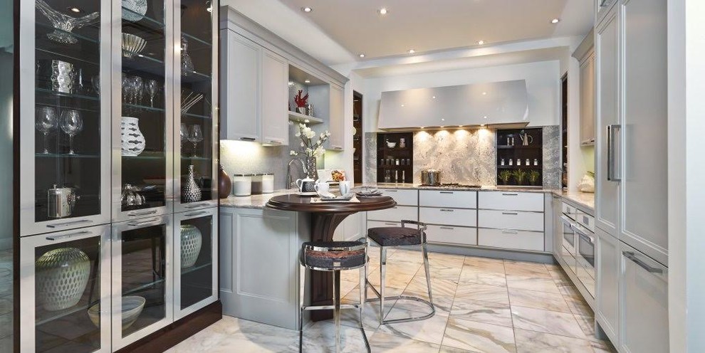 Design ideas for a mid-sized transitional u-shaped kitchen in Miami with an undermount sink, flat-panel cabinets, grey cabinets, granite benchtops, grey splashback, stone slab splashback and panelled appliances.