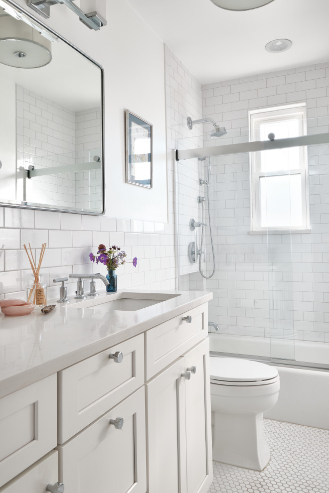 Inspiration for a mid-sized modern 3/4 bathroom in New York with shaker cabinets, white cabinets, an alcove tub, a shower/bathtub combo, a two-piece toilet, white tile, subway tile, white walls, mosaic tile floors, an undermount sink, quartzite benchtops, white floor, a sliding shower screen, white benchtops, a single vanity and a built-in vanity.