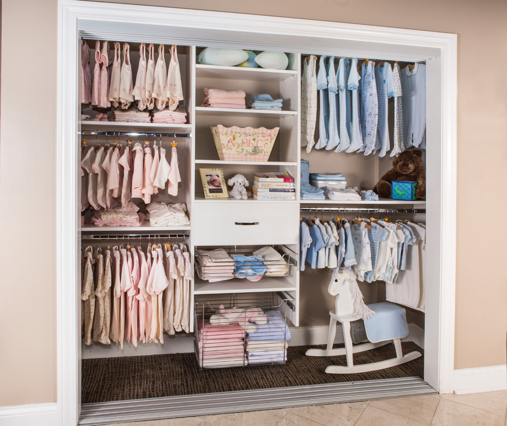 This is an example of a small transitional gender-neutral built-in wardrobe in Tampa with flat-panel cabinets, beige cabinets, porcelain floors and beige floor.