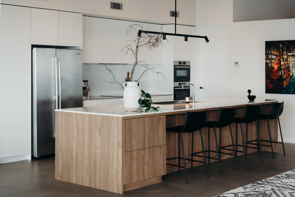 Design ideas for a large contemporary galley kitchen in Newcastle - Maitland with quartz benchtops, stone slab splashback, concrete floors and with island.