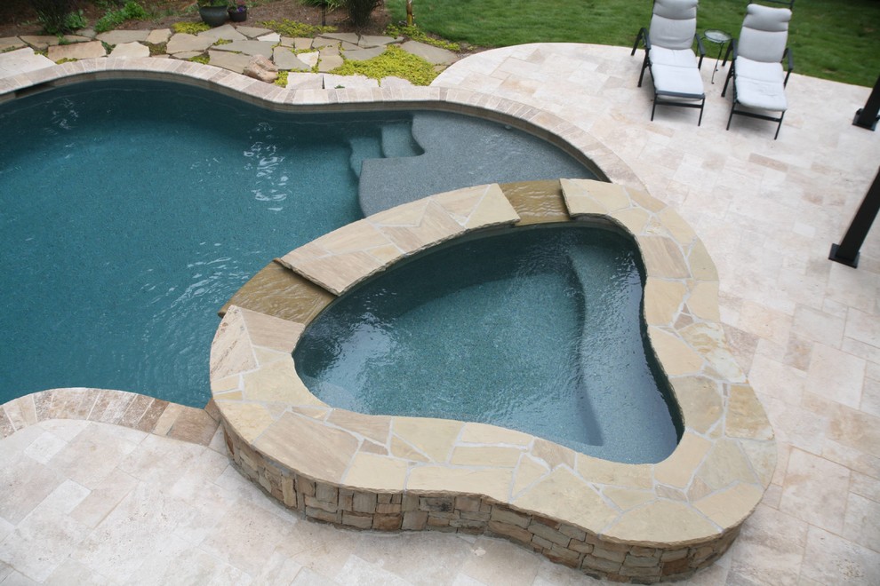 Inspiration for a mid-sized contemporary backyard stone and custom-shaped natural hot tub remodel