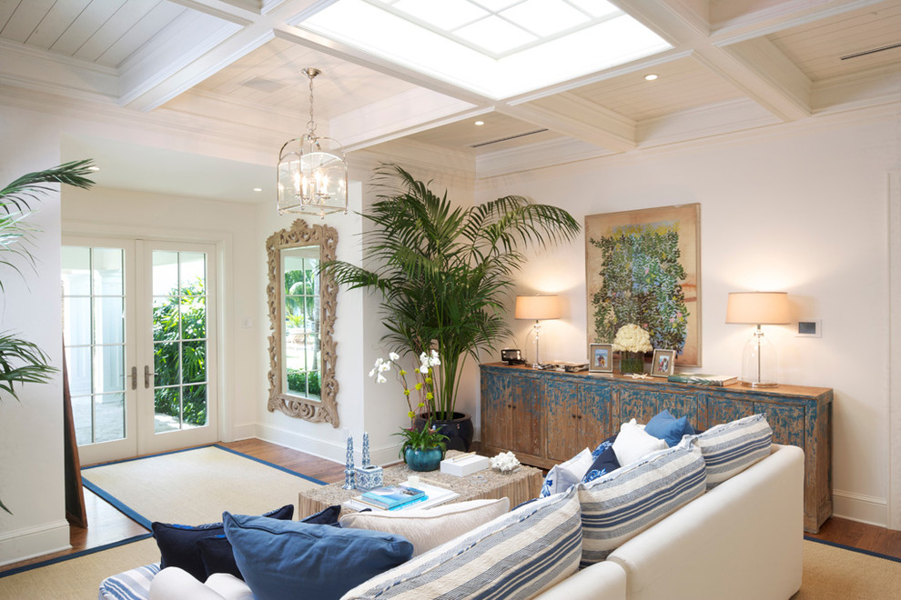 Photo of a beach style living room in Miami with white walls.