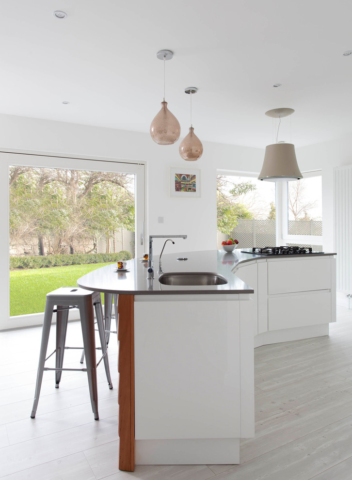 Design ideas for a large contemporary l-shaped open plan kitchen in Other with an undermount sink, flat-panel cabinets, white cabinets, quartzite benchtops, grey splashback, stone slab splashback, stainless steel appliances, light hardwood floors and with island.