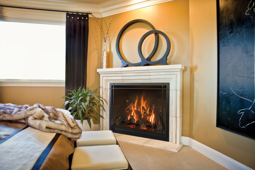 Example of a large transitional master carpeted bedroom design with yellow walls, a stone fireplace and a corner fireplace