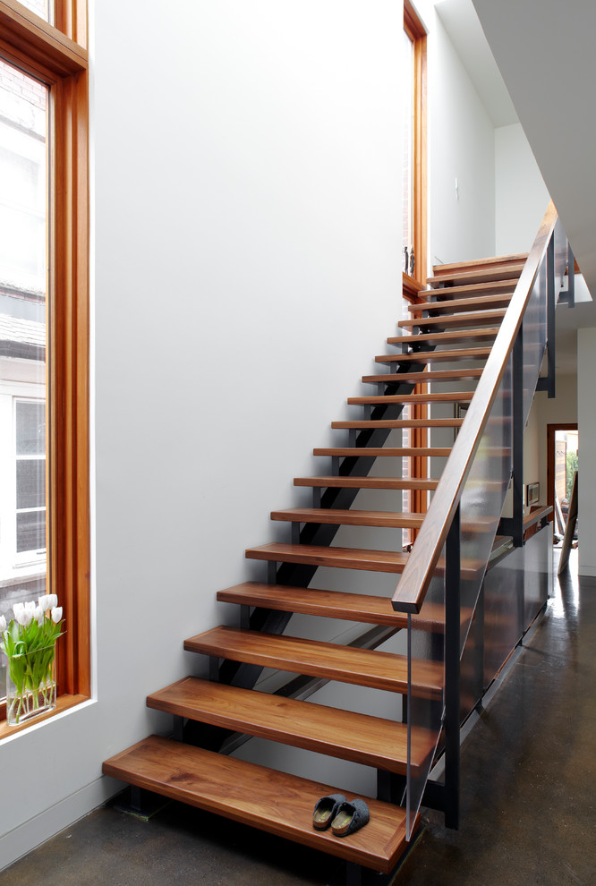 Mid-sized contemporary wood straight staircase in Toronto with open risers.