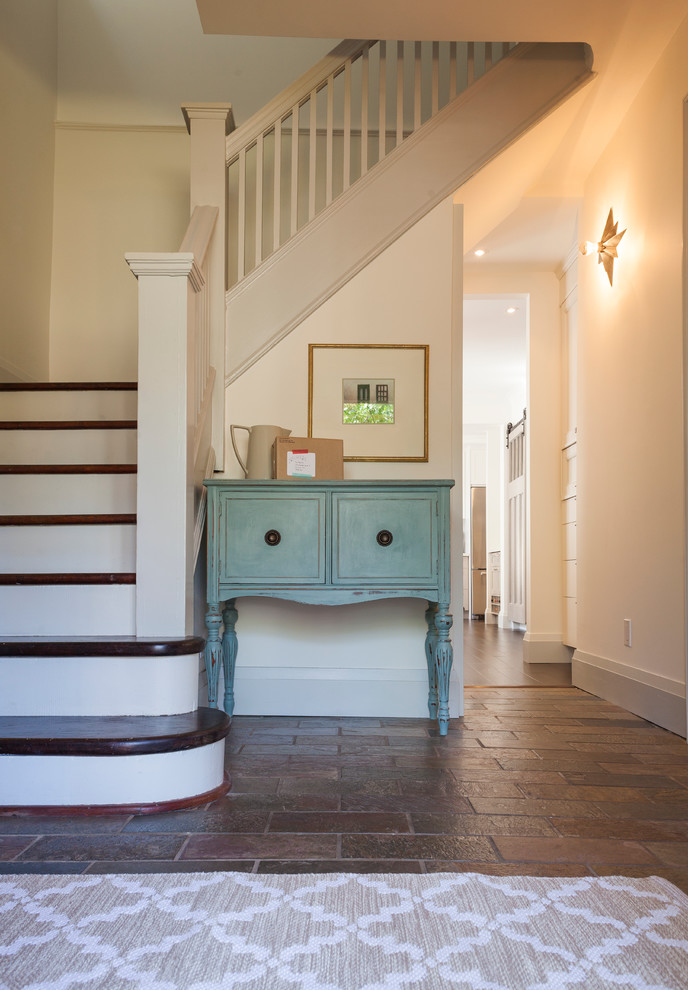 This is an example of a mid-sized eclectic wood l-shaped staircase in Other with painted wood risers.