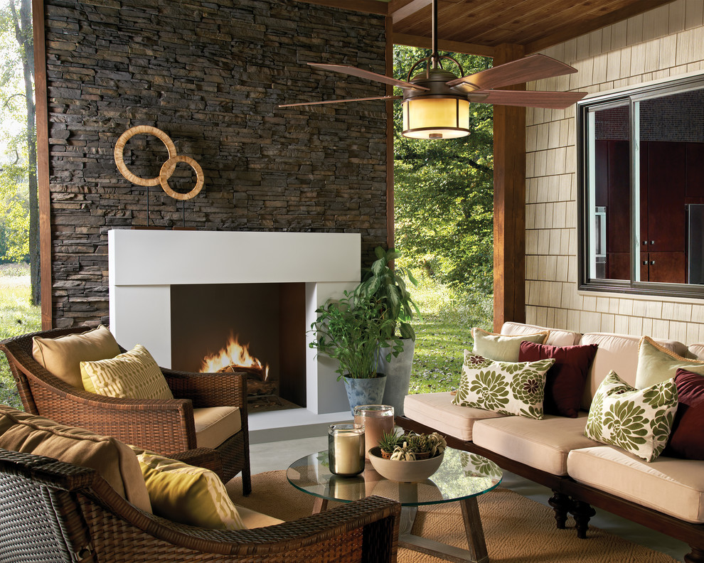 Design ideas for a mid-sized transitional backyard patio with a fire feature, a roof extension and concrete slab.