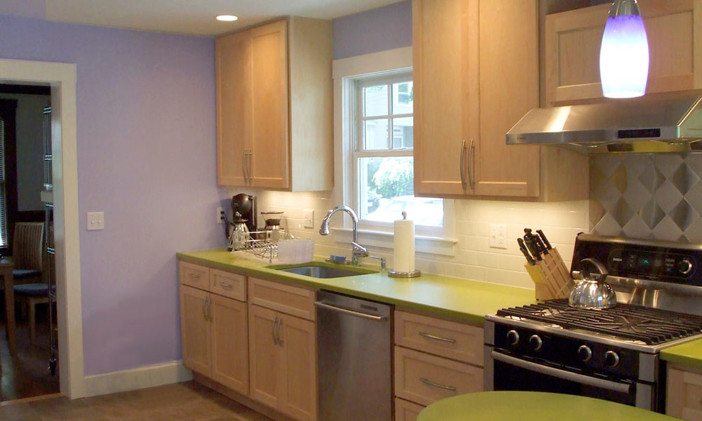 Inspiration for a small galley ceramic tile eat-in kitchen remodel in Boston with an undermount sink, shaker cabinets, light wood cabinets, solid surface countertops, metallic backsplash, metal backsplash, stainless steel appliances and a peninsula
