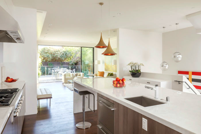 This is an example of a contemporary l-shaped eat-in kitchen in San Francisco with an undermount sink, flat-panel cabinets, medium wood cabinets, solid surface benchtops, white splashback, stainless steel appliances, medium hardwood floors and with island.