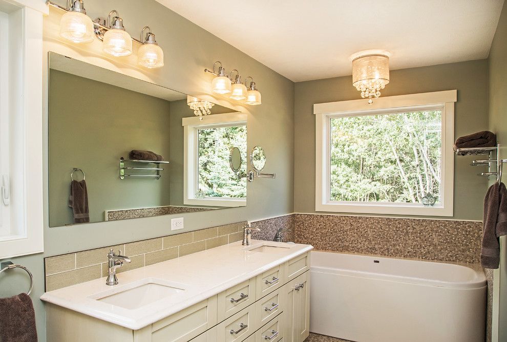 Freestanding bathtub - mid-sized transitional master beige tile and porcelain tile porcelain tile freestanding bathtub idea in Calgary with an undermount sink, shaker cabinets, white cabinets, quartz countertops and blue walls
