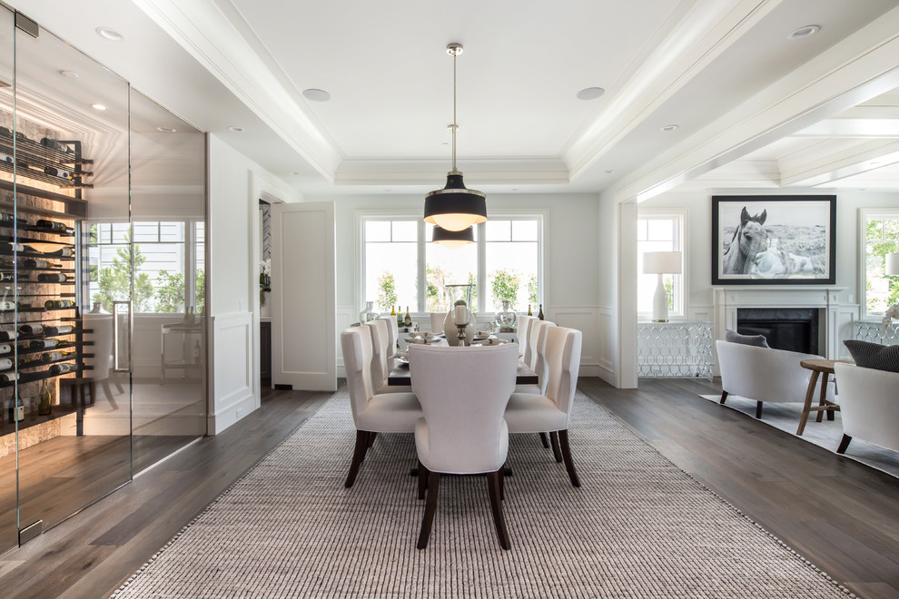 This is an example of a mid-sized traditional open plan dining in Los Angeles with white walls, medium hardwood floors and brown floor.