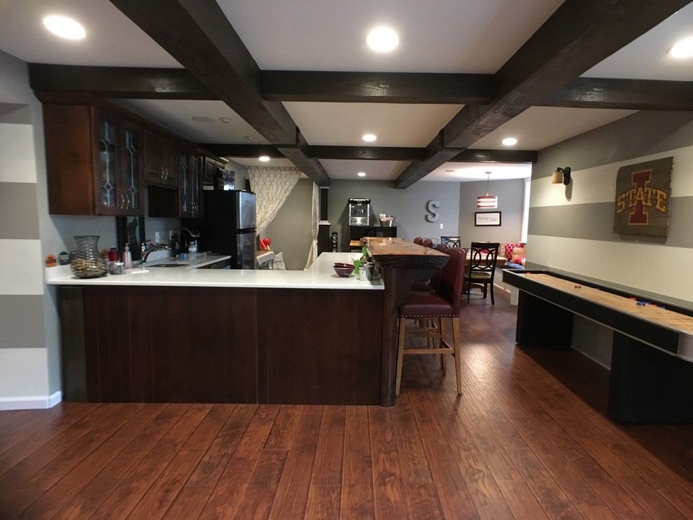 Example of a transitional dark wood floor and brown floor basement design with gray walls