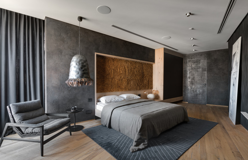 Идея дизайна: гостевая спальня среднего размера, (комната для гостей): освещение в стиле лофт с черными стенами, паркетным полом среднего тона, коричневым полом и панелями на части стены