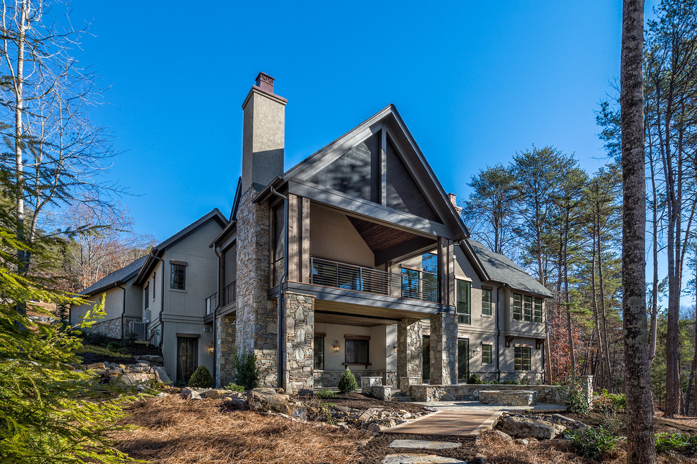 Large rustic brown two-story stucco exterior home idea