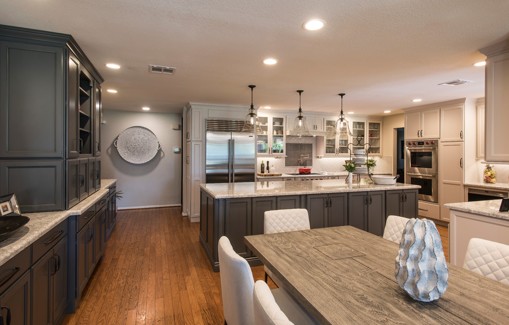 Large transitional l-shaped medium tone wood floor and brown floor eat-in kitchen photo in Phoenix with a farmhouse sink, shaker cabinets, gray cabinets, quartz countertops, white backsplash, subway tile backsplash, stainless steel appliances, an island and white countertops