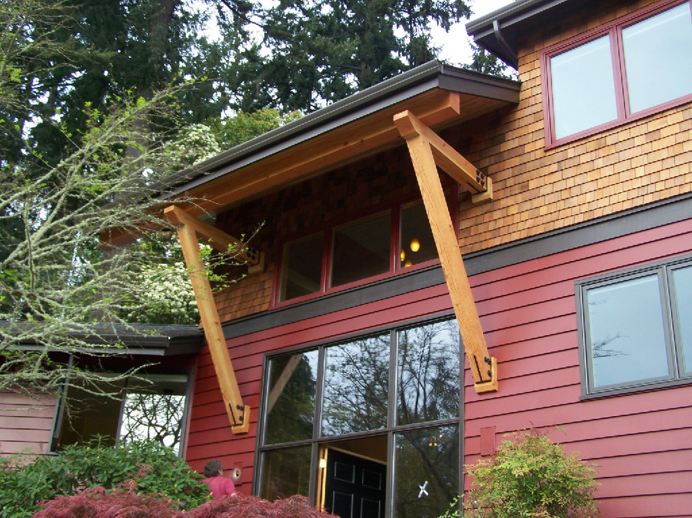 Design ideas for a large country two-storey red exterior in Portland with wood siding.