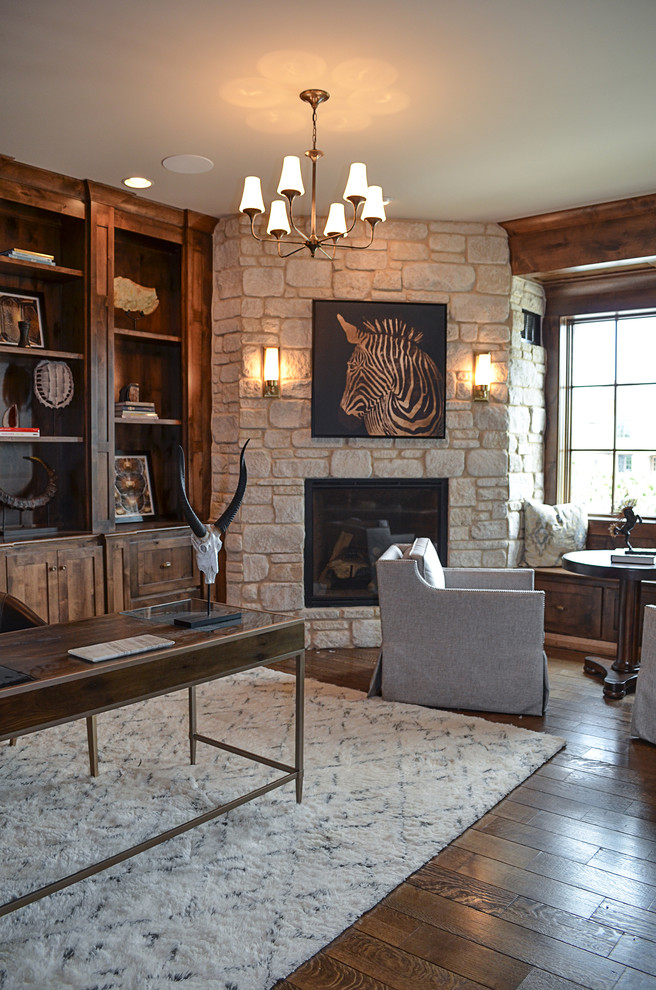 Inspiration for a large contemporary study room in Chicago with beige walls, a corner fireplace, a stone fireplace surround, a freestanding desk and dark hardwood floors.
