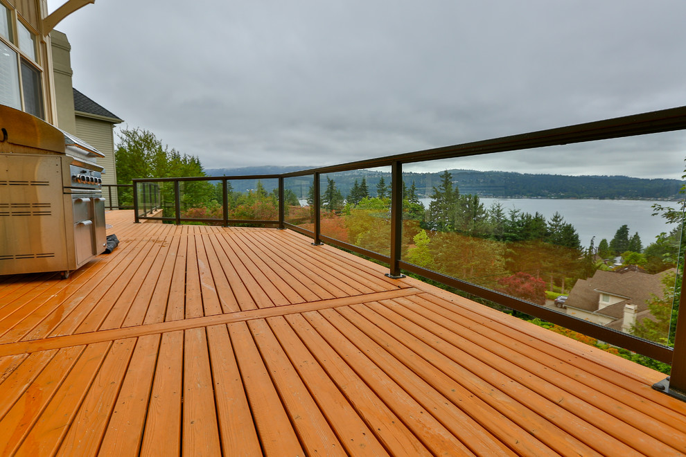 Inspiration for a large arts and crafts backyard deck in Seattle with no cover and a fire feature.