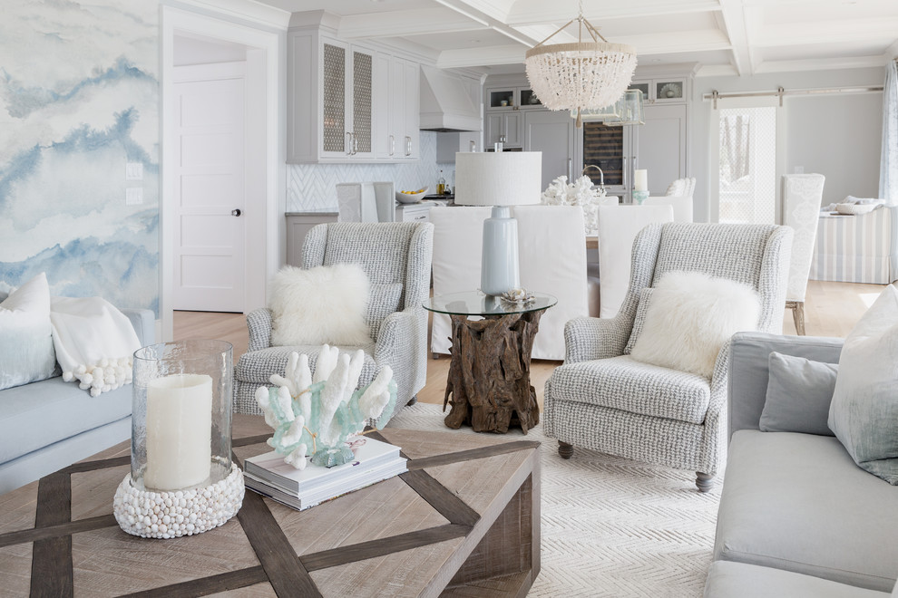 Example of a large beach style open concept light wood floor and beige floor living room design in Boston with blue walls, a standard fireplace, a tile fireplace and a wall-mounted tv