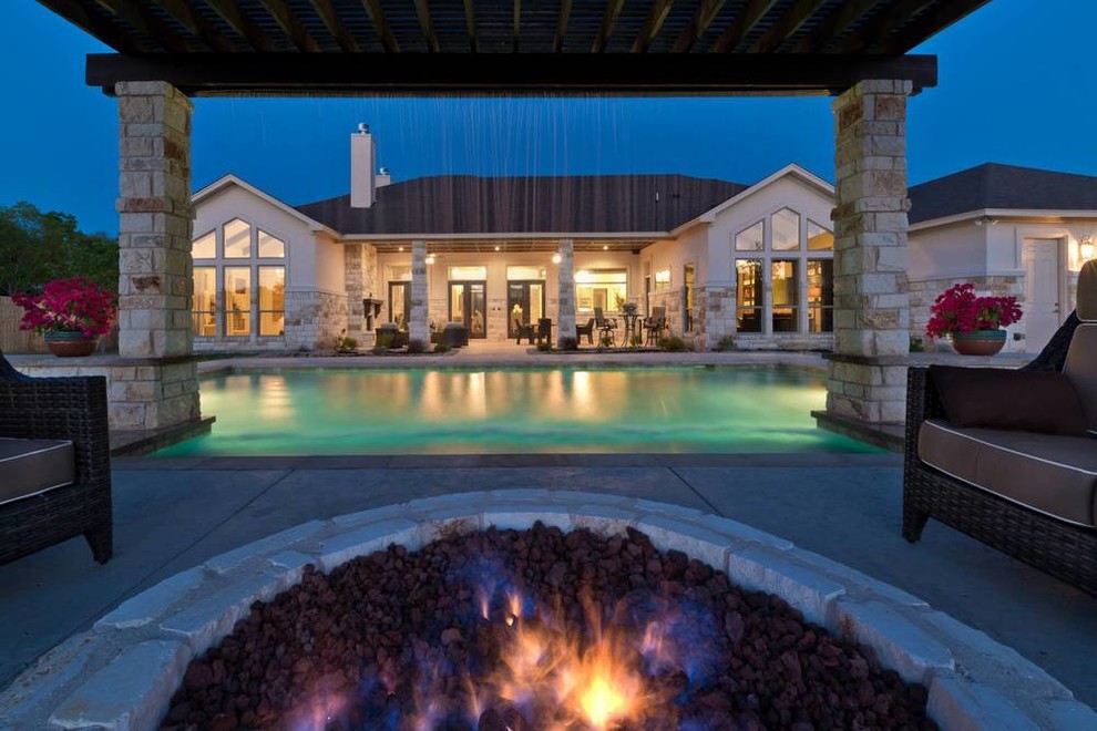 Example of a transitional backyard concrete and rectangular pool fountain design in Austin