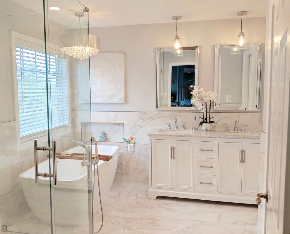 Mid-sized transitional master gray tile and ceramic tile ceramic tile and gray floor freestanding bathtub photo in DC Metro with shaker cabinets, white cabinets, a one-piece toilet, gray walls, an undermount sink, marble countertops, a hinged shower door and gray countertops