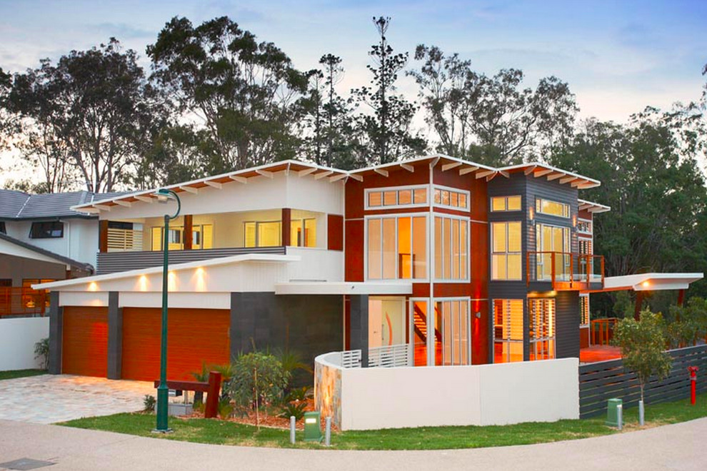Inspiration for a large contemporary two-storey multi-coloured house exterior in Brisbane with mixed siding, a flat roof and a metal roof.