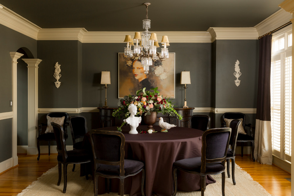 Inspiration for a mid-sized traditional separate dining room in Atlanta with medium hardwood floors and black walls.