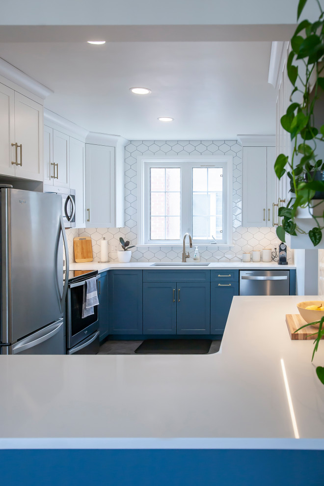 Example of a mid-sized transitional l-shaped eat-in kitchen design with an undermount sink, blue cabinets, quartz countertops, white backsplash, porcelain backsplash, stainless steel appliances, no island and white countertops