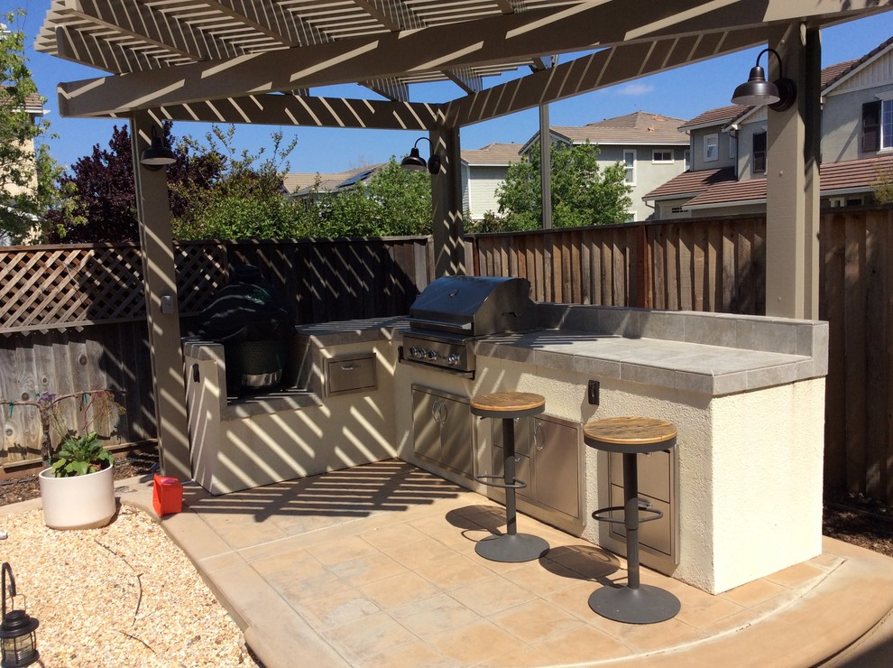 Photo of a large traditional backyard patio in San Francisco with stamped concrete, a pergola and an outdoor kitchen.