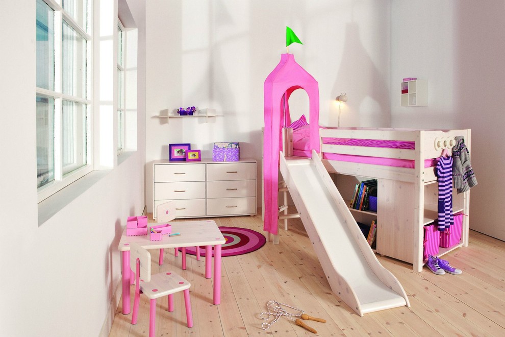 Large kids' bedroom in Hawaii with white walls and light hardwood floors for girls.