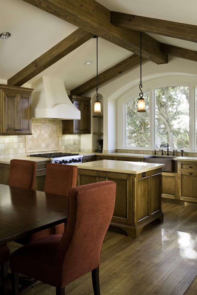 This is an example of a mediterranean eat-in kitchen in Other with medium wood cabinets and beige splashback.