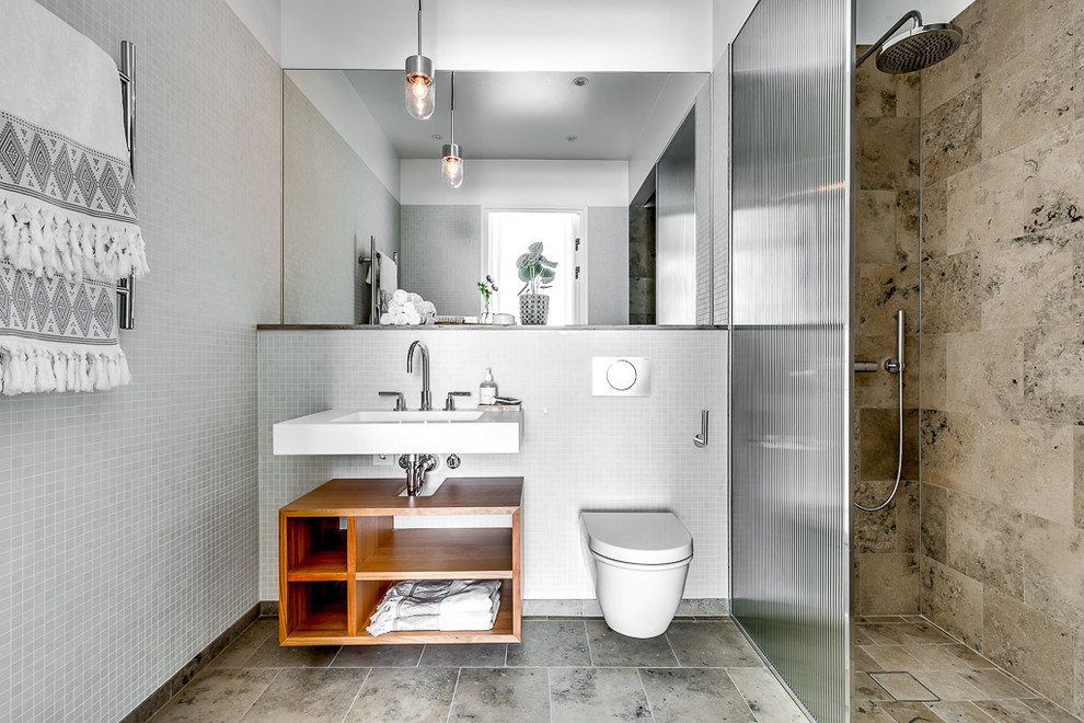 This is an example of a large modern 3/4 bathroom in Stockholm with open cabinets, medium wood cabinets, an alcove shower, a wall-mount toilet, multi-coloured tile and multi-coloured walls.