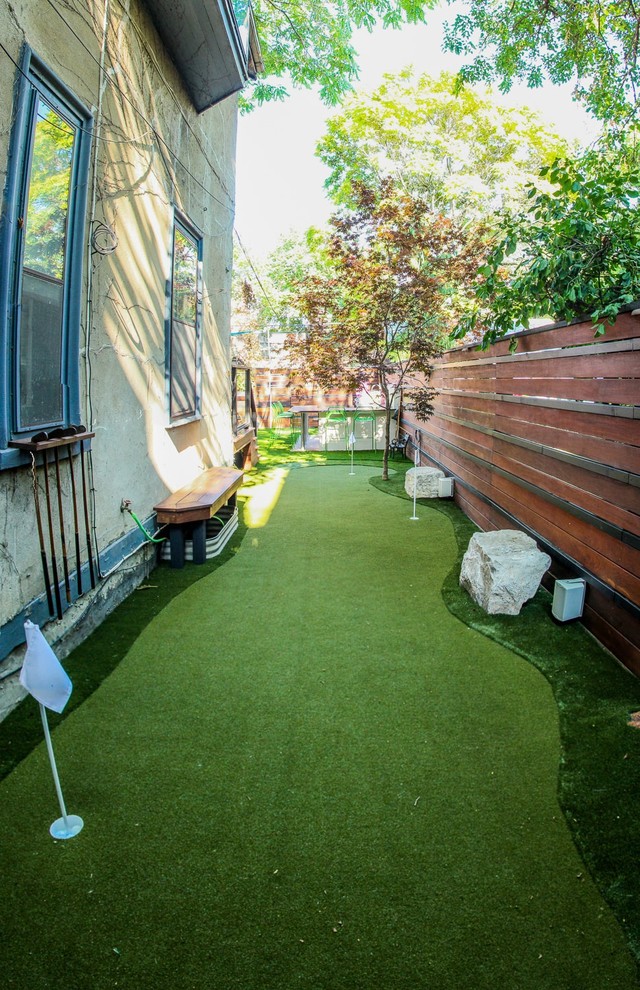 Photo of a mid-sized traditional backyard partial sun outdoor sport court in Toronto.